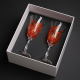 Two hand-painted and decorated wine glasses in a decorative hand-made box.